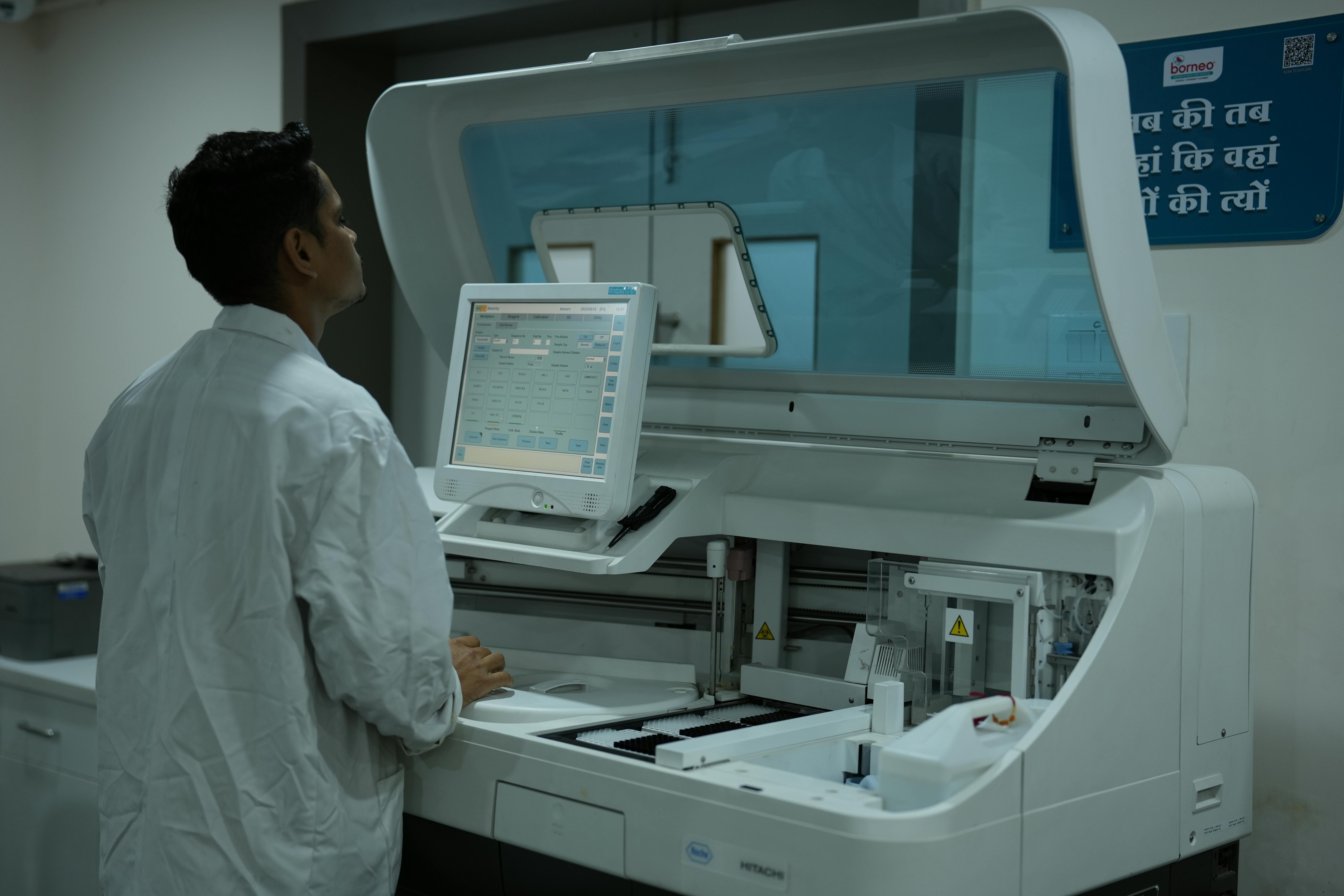 Medical professional operating modern diagnostic laboratory equipment
